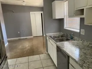 a kitchen with a sink a stove and cabinets