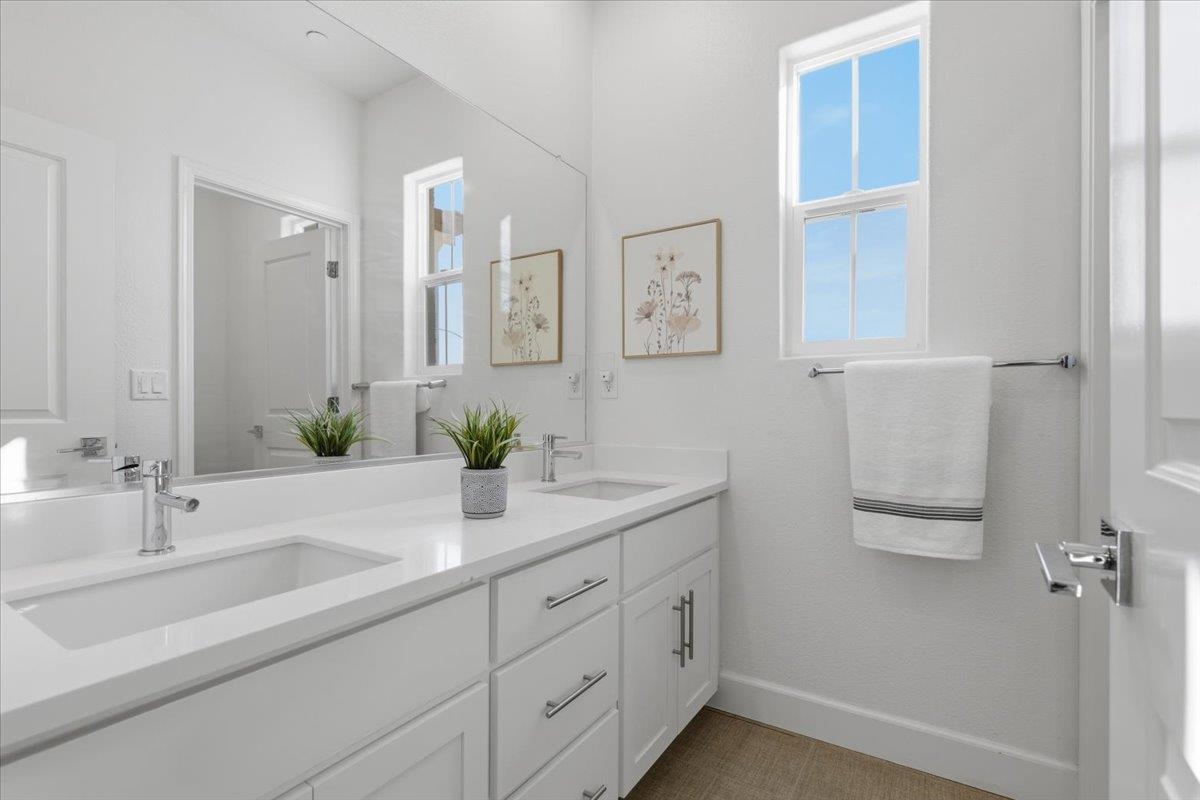 2481 Azalea Avenue Tracy, CA 95376 - Photo 14 of 31 a bathroom with a double vanity sink and a mirror