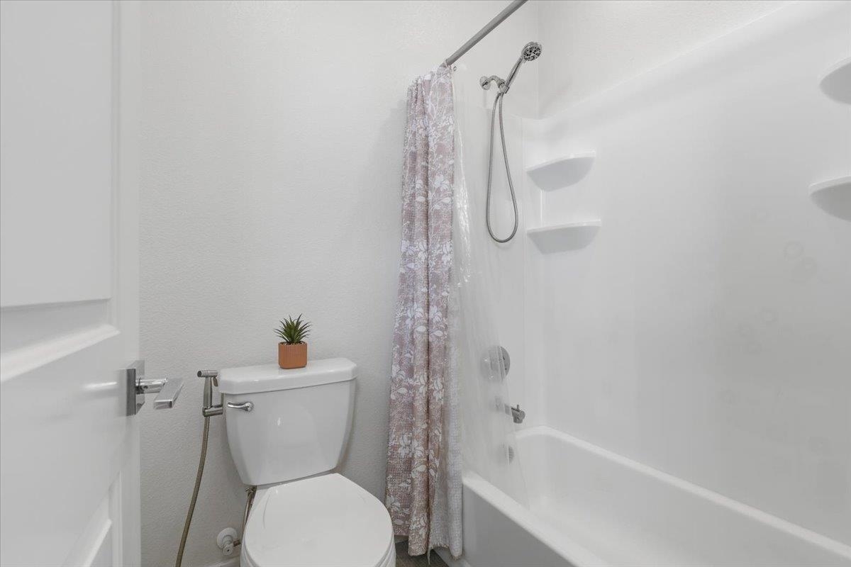 2481 Azalea Avenue Tracy, CA 95376 - Photo 15 of 31 a bathroom with a toilet and a shower