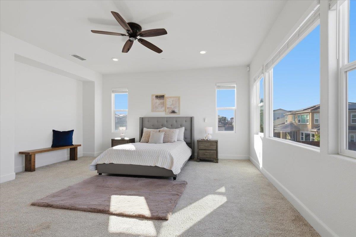 2481 Azalea Avenue Tracy, CA 95376 - Photo 18 of 31 a spacious bedroom with a bed a window and a chandelier