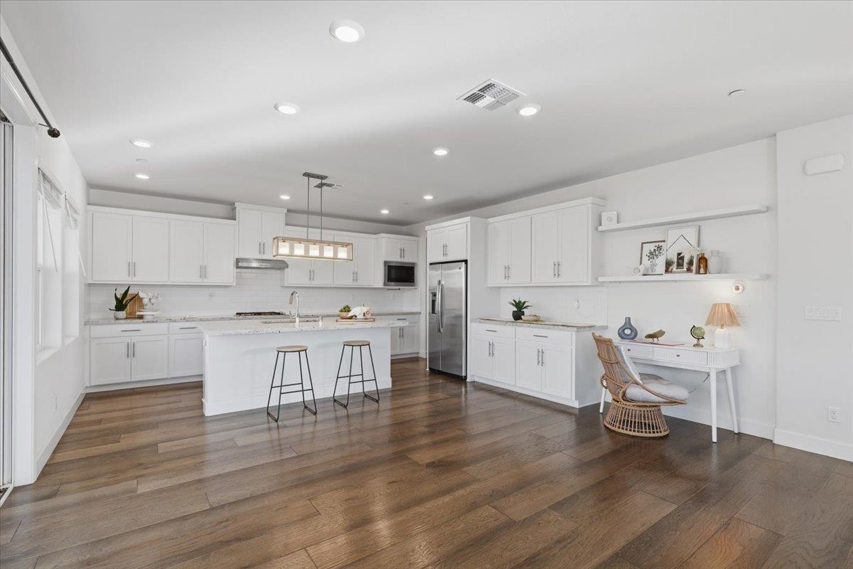 2481 Azalea Avenue Tracy, CA 95376 - Photo 8 of 31 a kitchen with a white counter top space cabinets and stainless steel appliances