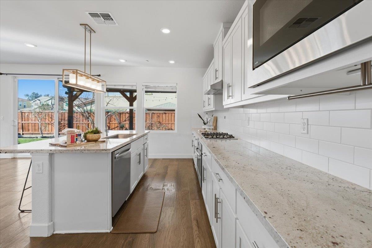 2481 Azalea Avenue Tracy, CA 95376 - Photo 10 of 31 a kitchen with sink cabinets and wooden floor
