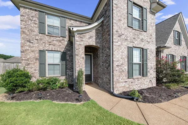 a kitchen with granite countertop kitchen island granite countertop a table chairs sink and cabinets