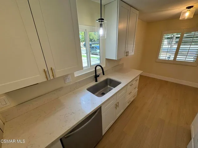 a kitchen with stainless steel appliances a sink and a window