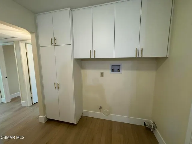 an empty room with wooden floor and closet
