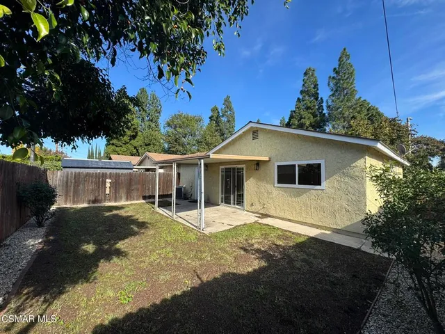 a view of a house with a backyard