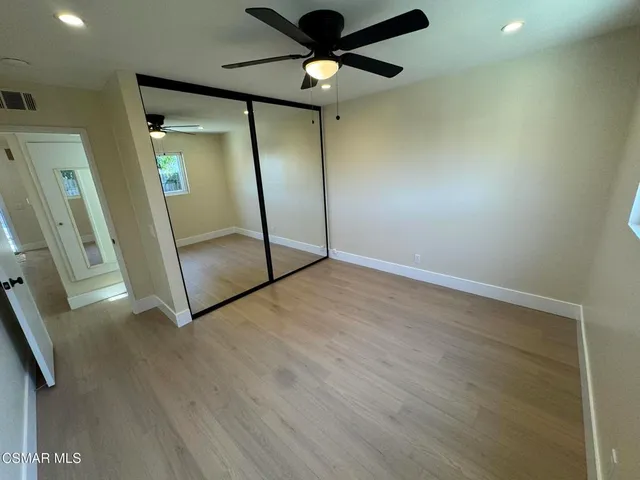 a view of an empty room with a mirror