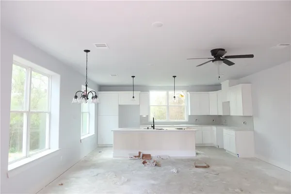 a view of a kitchen with a sink stainless steel appliances and cabinets
