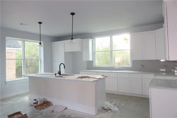 a kitchen with a sink window and cabinets