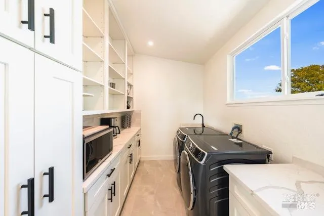 a kitchen with a sink and a stove top oven