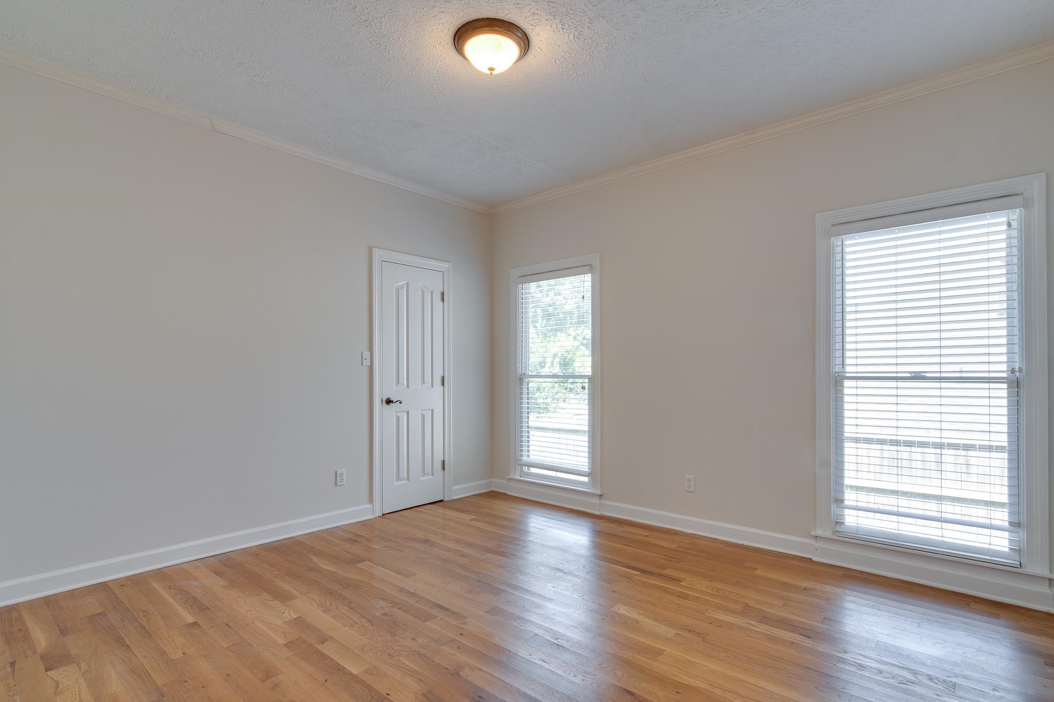 4306 Wind Tree Cove Bartlett, TN 38135 - Photo 13 of 28 an empty room with wooden floor and windows