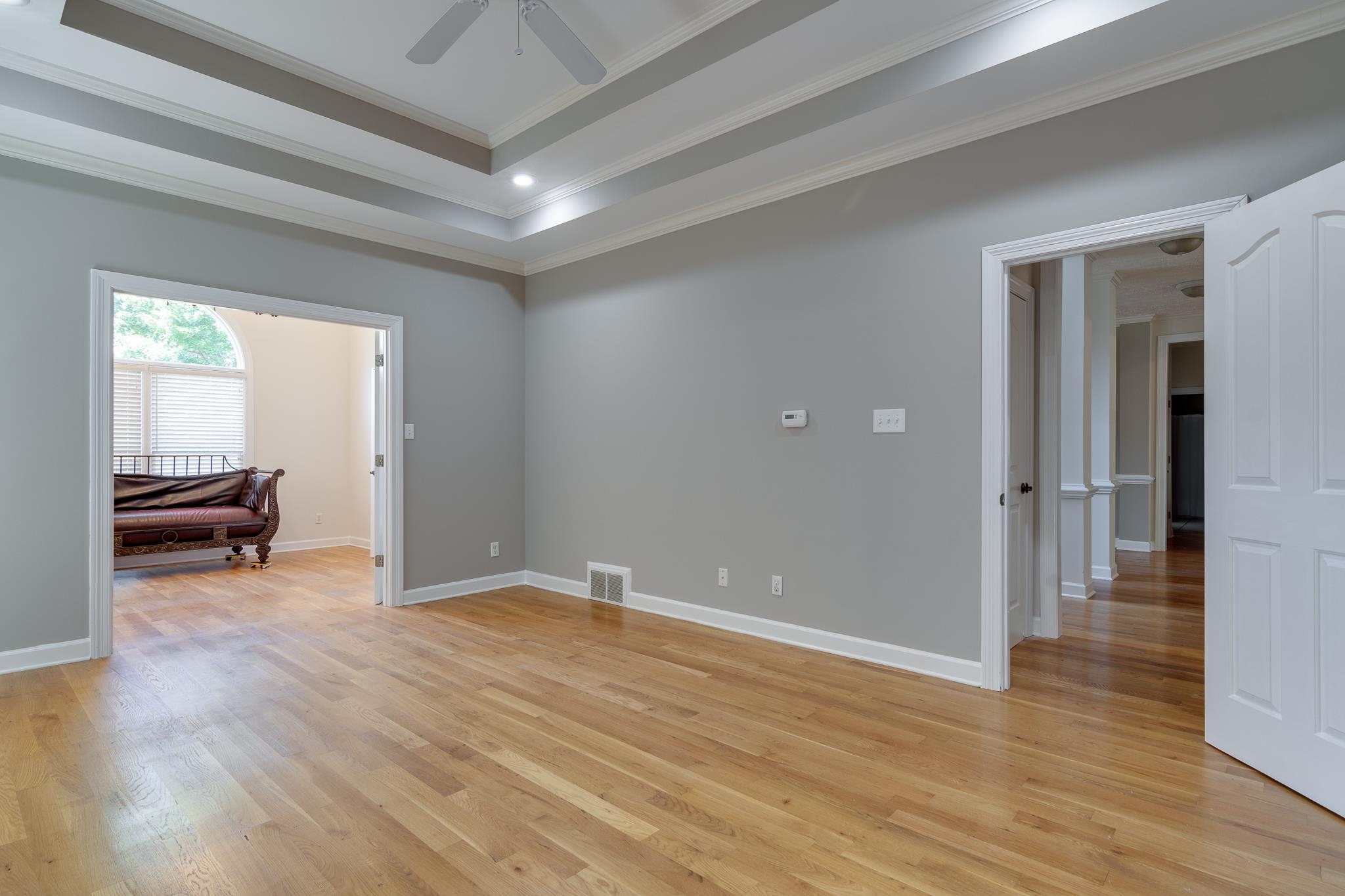 4306 Wind Tree Cove Bartlett, TN 38135 - Photo 19 of 28 an empty room with wooden floor and furniture