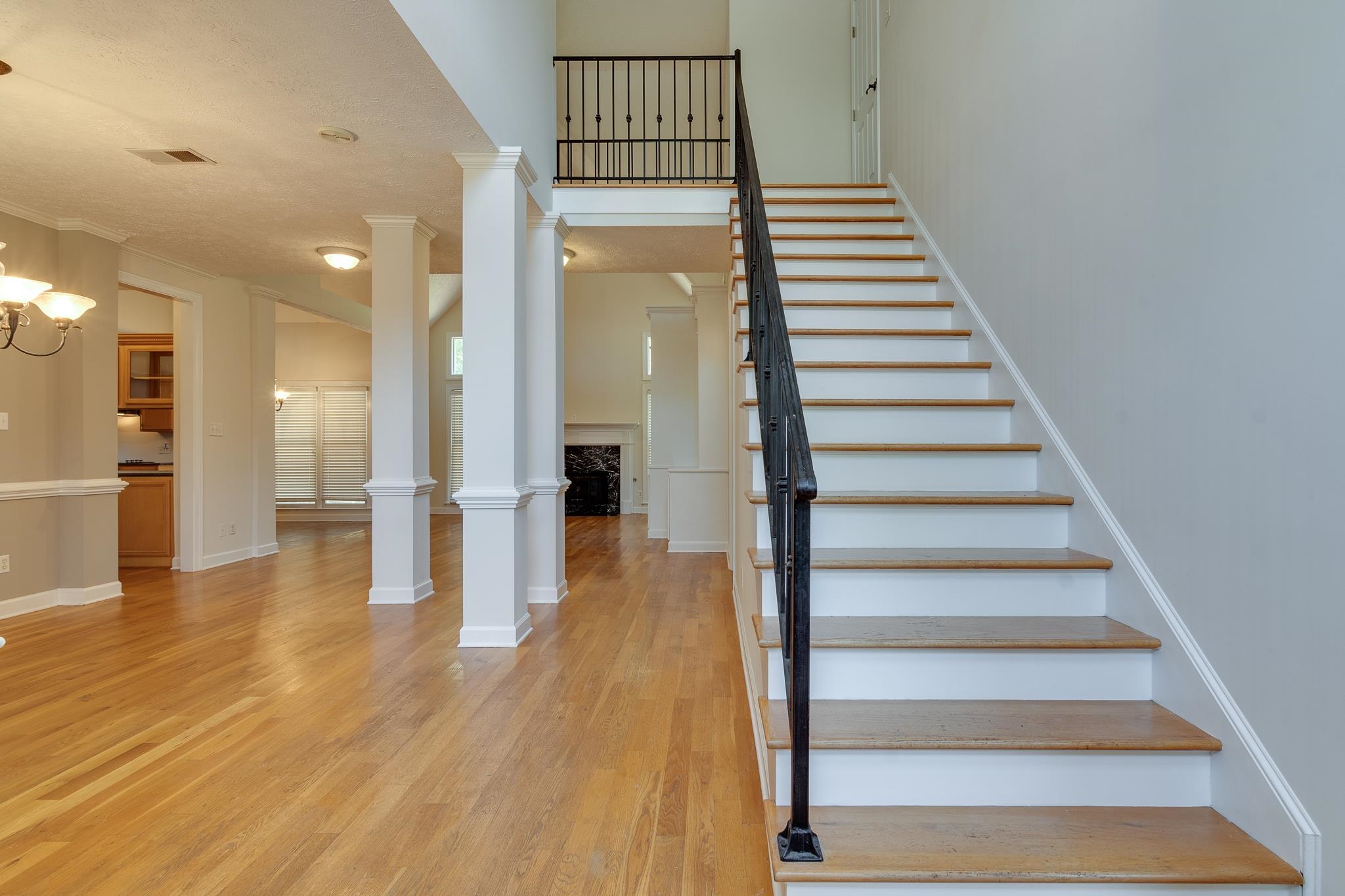 4306 Wind Tree Cove Bartlett, TN 38135 - Photo 2 of 28 a view of a hallway with wooden floor and staircase