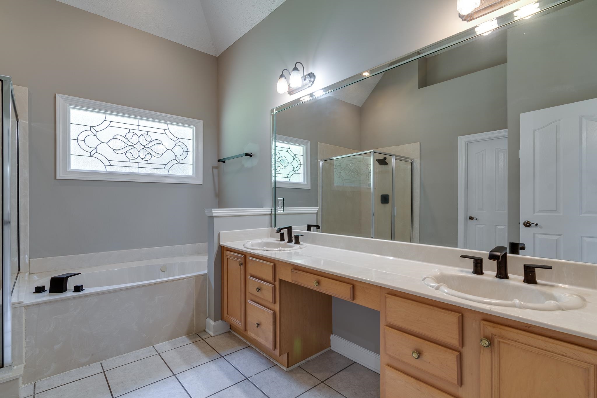4306 Wind Tree Cove Bartlett, TN 38135 - Photo 21 of 28 a bathroom with a granite countertop sink mirror bathtub and double