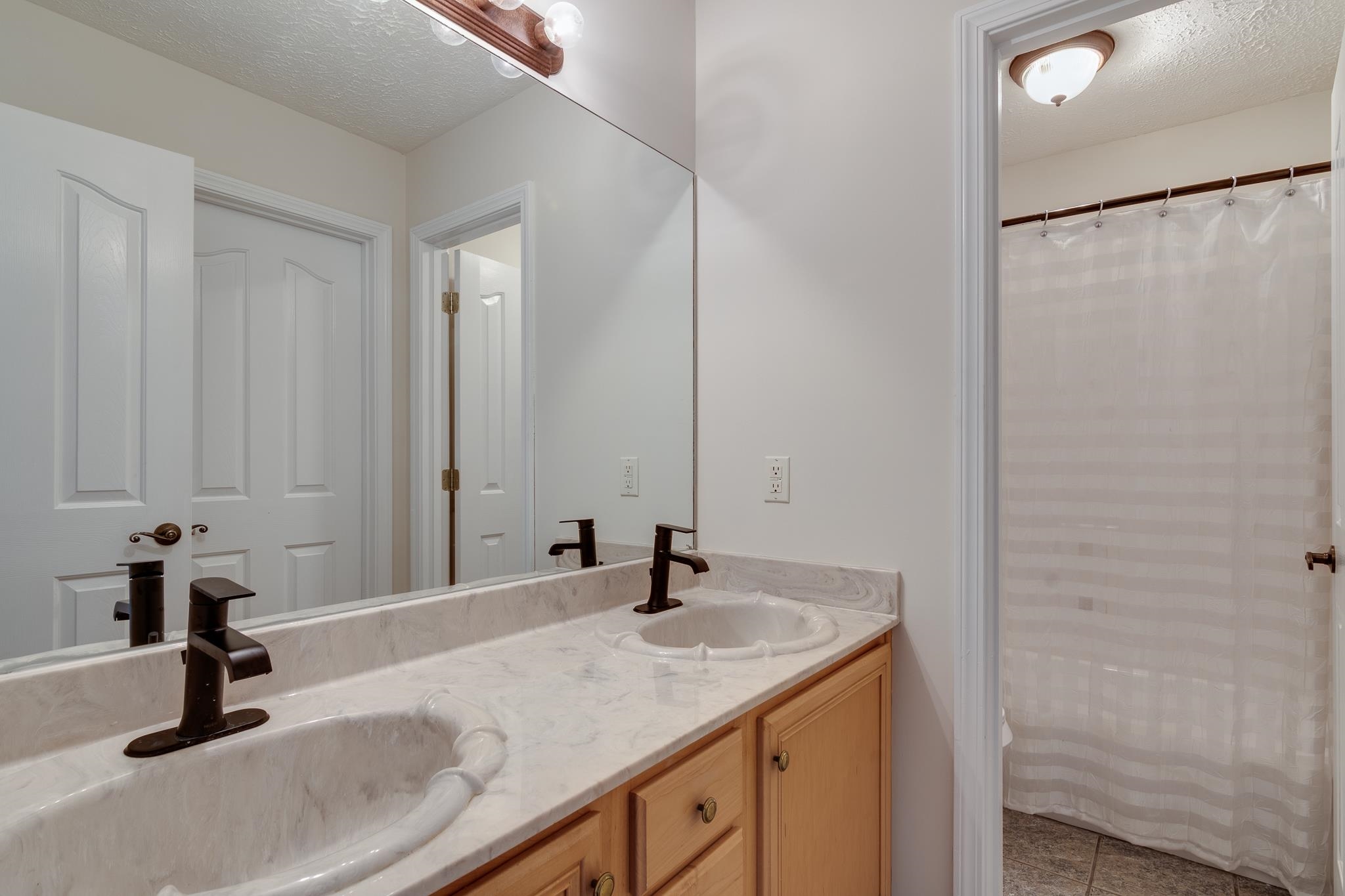 4306 Wind Tree Cove Bartlett, TN 38135 - Photo 25 of 28 a bathroom with a sink and a mirror