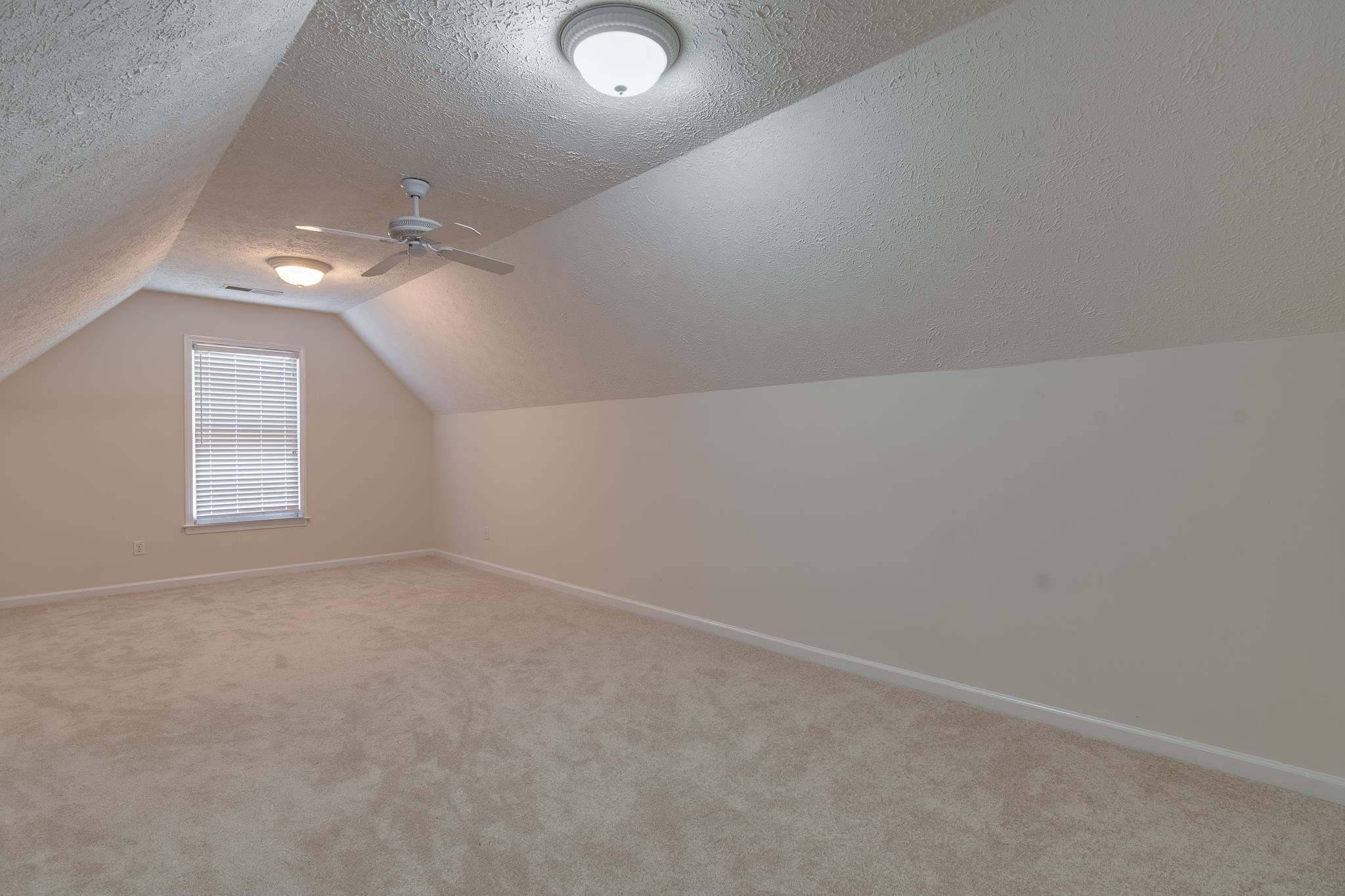 4306 Wind Tree Cove Bartlett, TN 38135 - Photo 26 of 28 en empty room with windows and fan