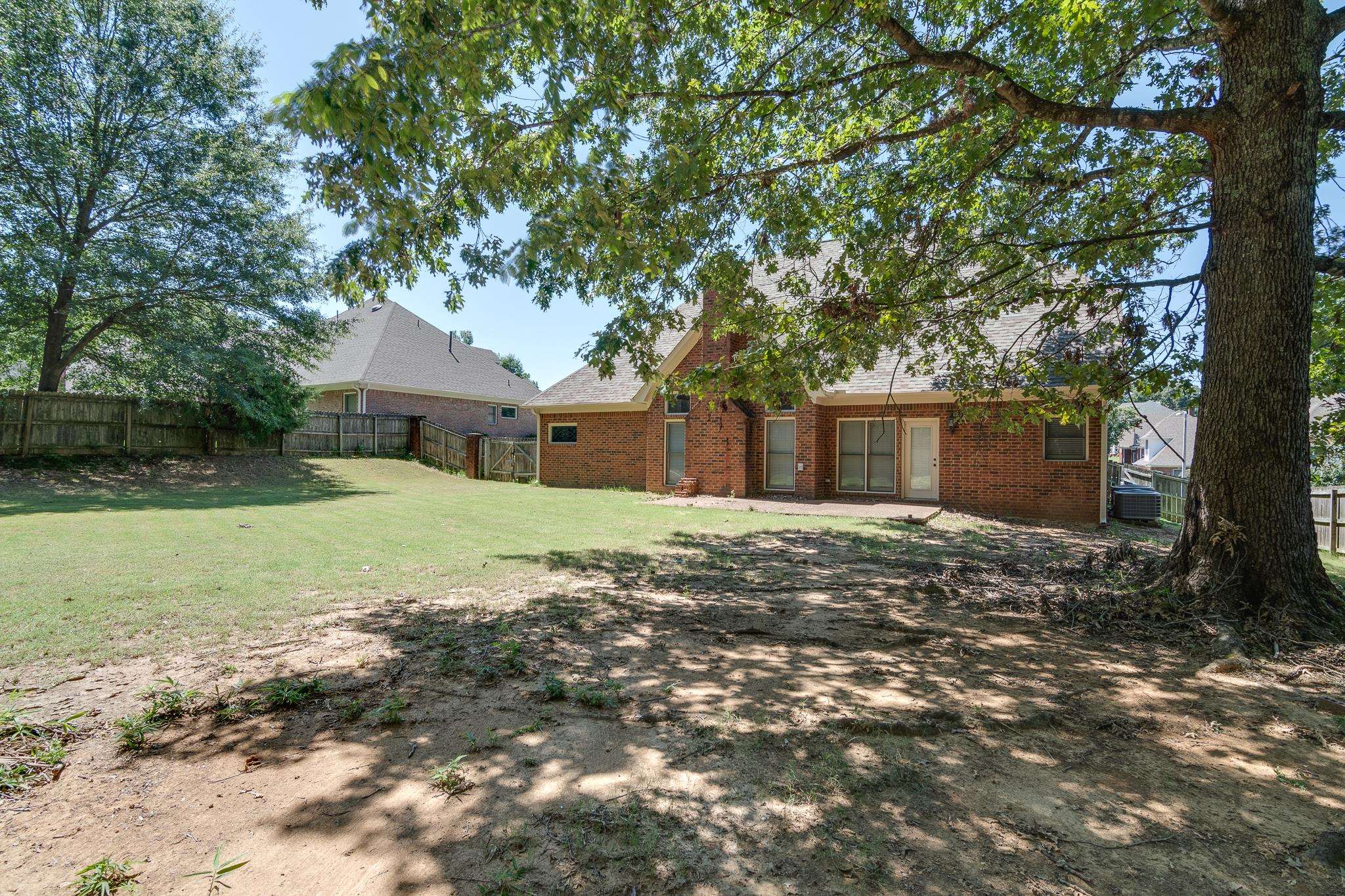 4306 Wind Tree Cove Bartlett, TN 38135 - Photo 27 of 28 a front view of a house with a yard and garage