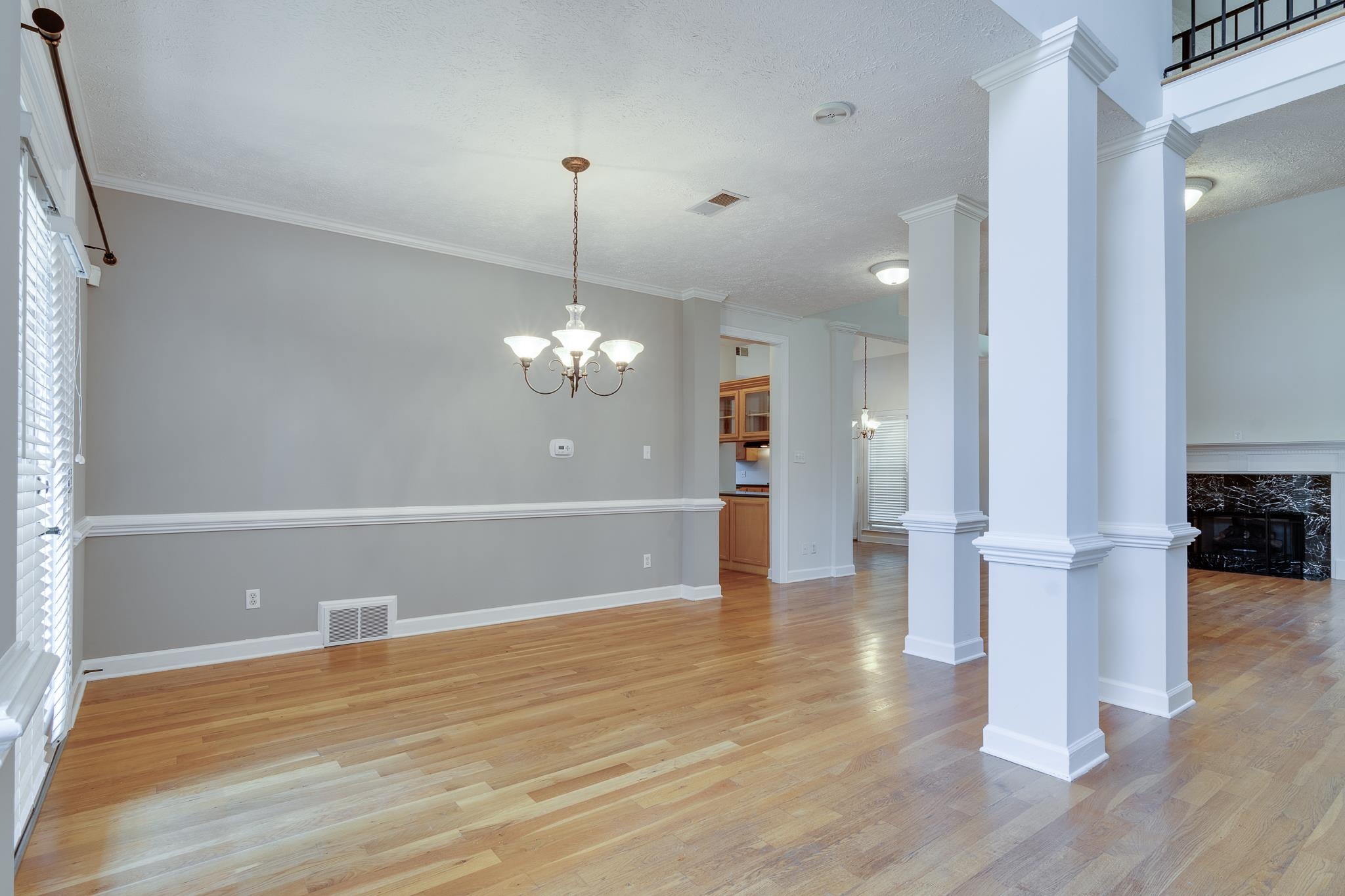 4306 Wind Tree Cove Bartlett, TN 38135 - Photo 4 of 28 a view of empty room with wooden floor and kitchen view