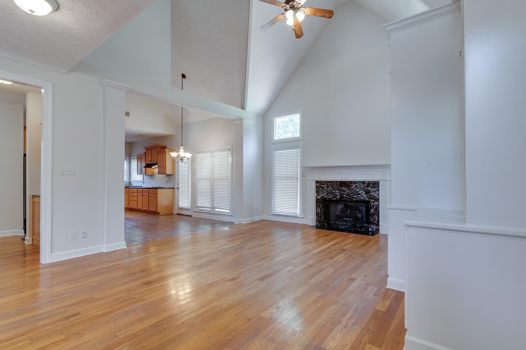 4306 Wind Tree Cove Bartlett, TN 38135 - Photo 5 of 28 a view of a livingroom with a fireplace a ceiling fan and windows