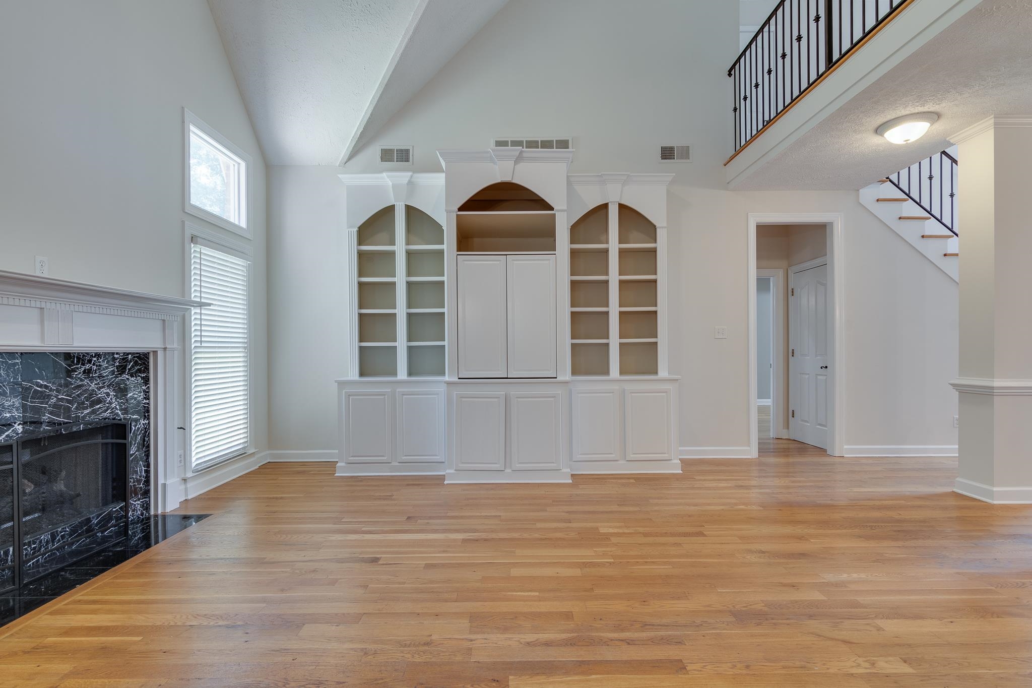 4306 Wind Tree Cove Bartlett, TN 38135 - Photo 7 of 28 a view of empty room with wooden floor and fireplace