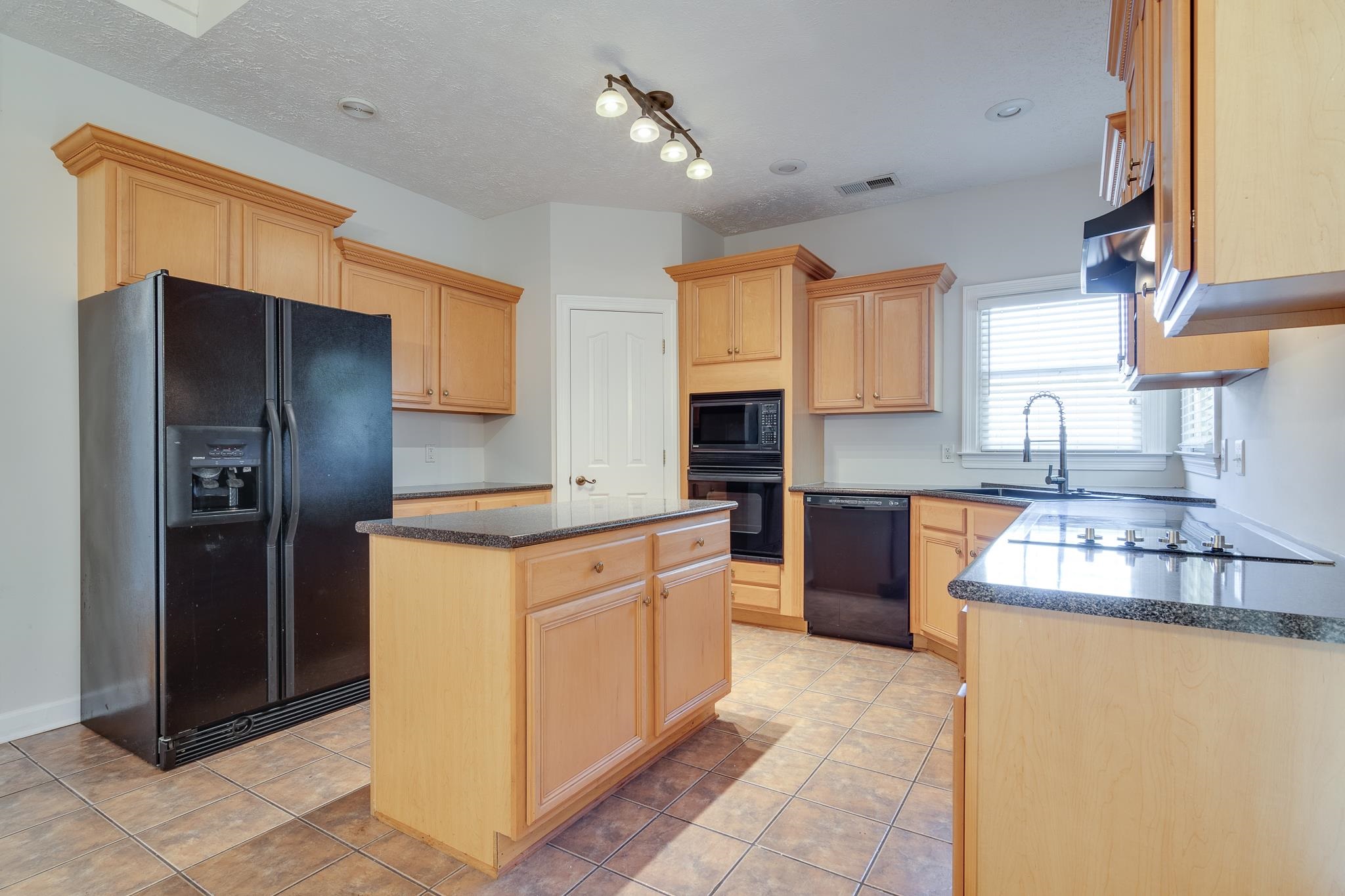 4306 Wind Tree Cove Bartlett, TN 38135 - Photo 10 of 28 a kitchen with stainless steel appliances granite countertop a refrigerator and a sink
