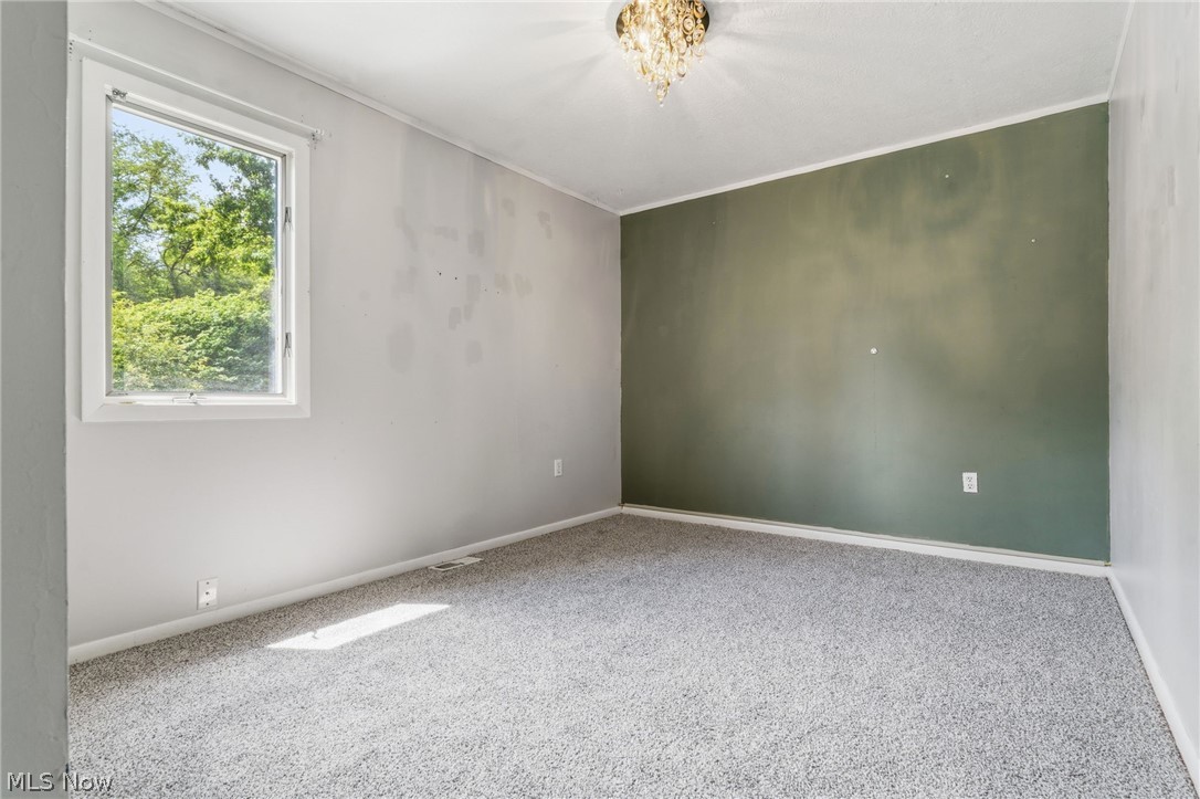 4449 18th Street Northwest Canton, OH 44708 - Photo 11 of 25 Carpeted room featuring a single window and two-tone wall treatment