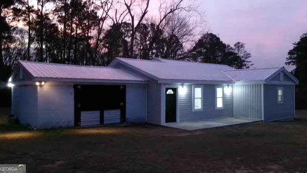 a front view of a house with lots of green space