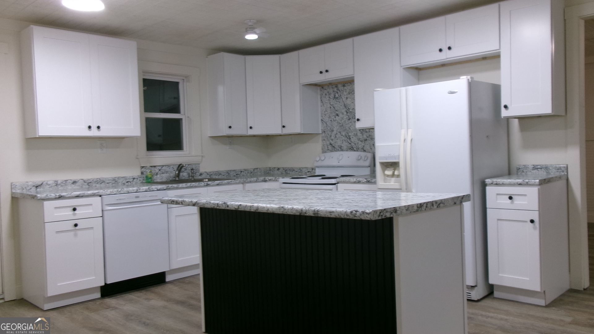 17827 Highway 129 Claxton, GA 30417 - Photo 16 of 21 a kitchen with stainless steel appliances granite countertop a sink stove and refrigerator