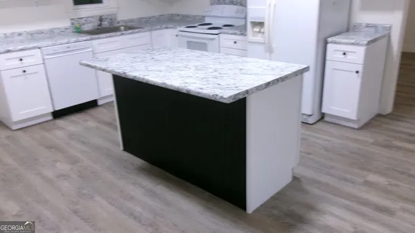 a utility room with cabinets washer and dryer