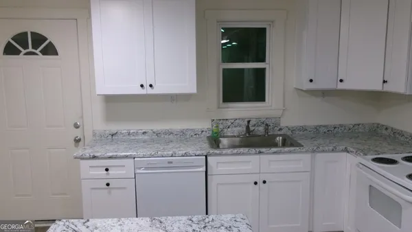 a kitchen with a stove and a refrigerator