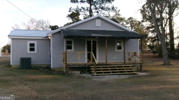 a front view of a house with a garden