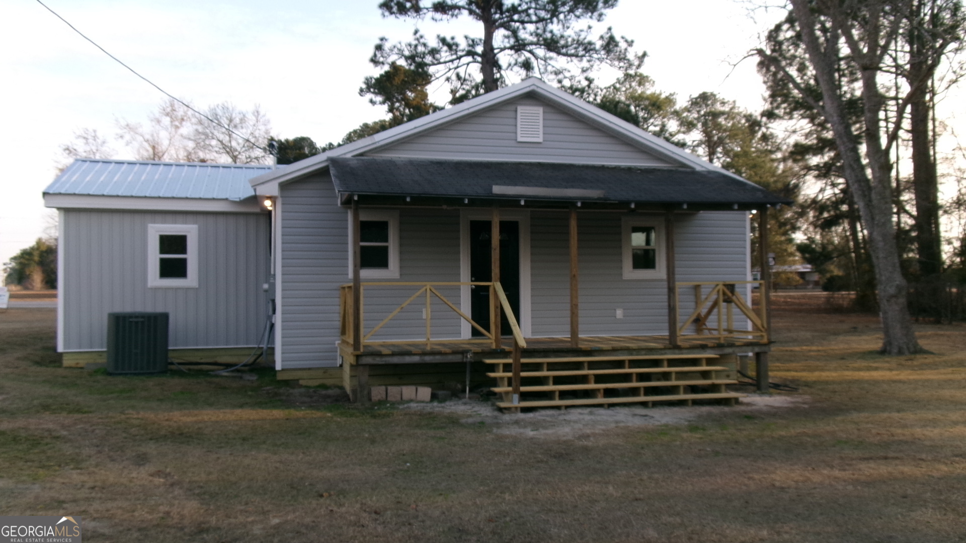 17827 Highway 129 Claxton, GA 30417 - Photo 3 of 21 a front view of a house with a garden