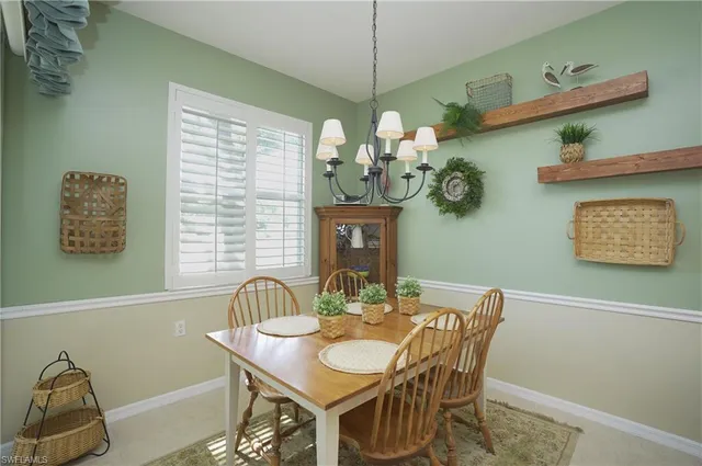 a view of a dining room with furniture and chandelier