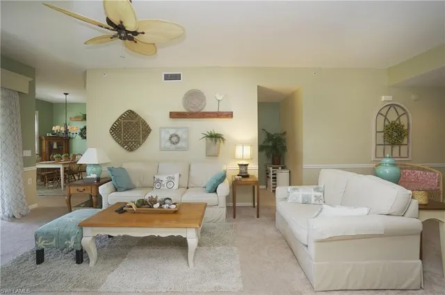 a living room with furniture and a clock