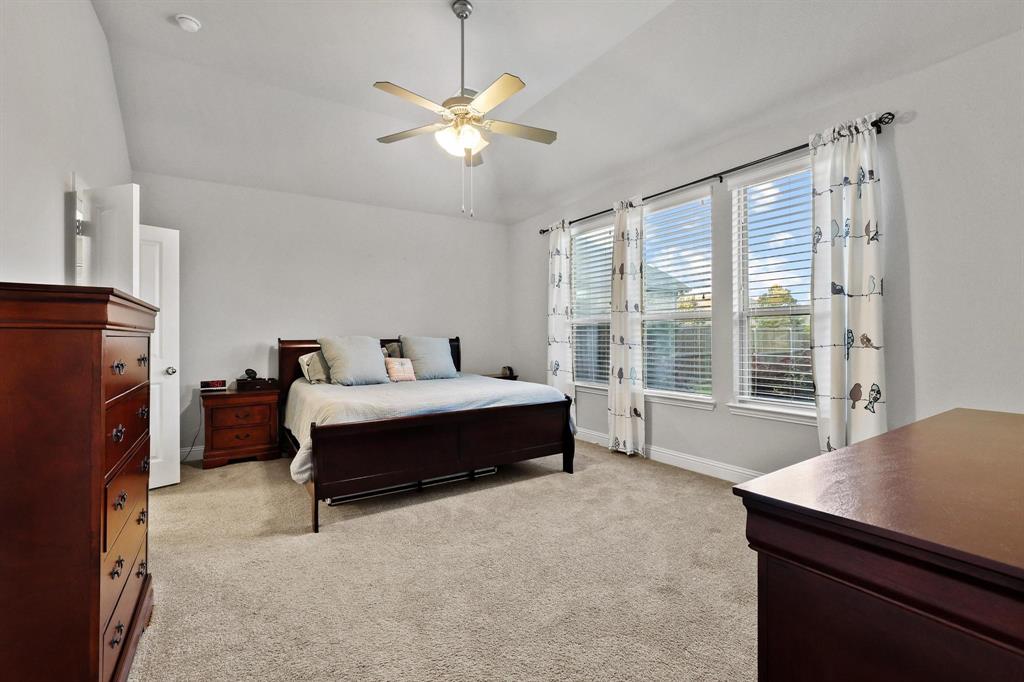 3500 Jersey Road Melissa, TX 75454 - Photo 14 of 40 a spacious bedroom with a bed and a chandelier