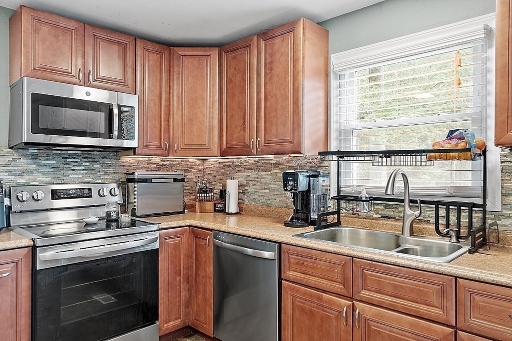 21 Chestnut Hill Road Orange, MA 01364 - Photo 8 of 37 a kitchen with stainless steel appliances granite countertop a sink stove microwave and cabinets