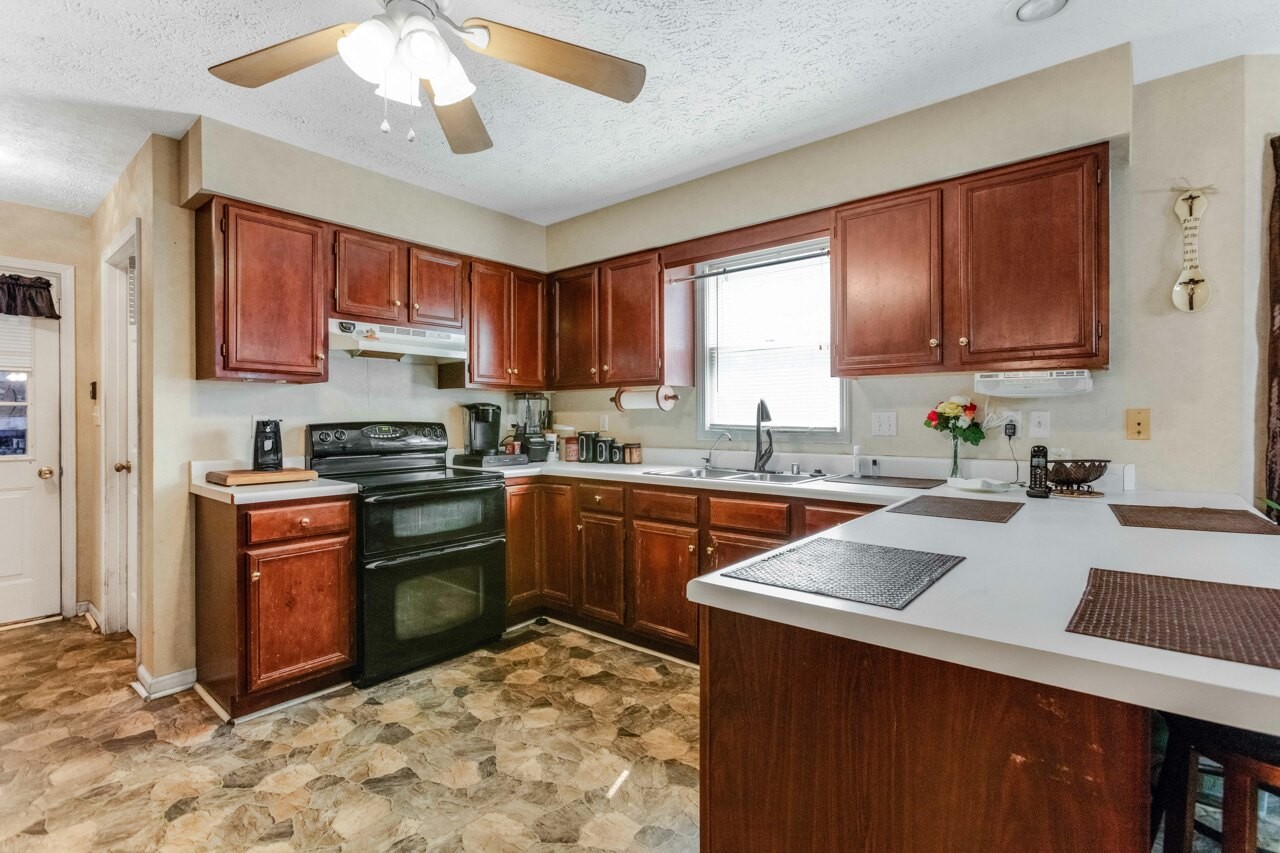 1512 Oak Ridge Court Hopkinsville, KY 42240 - Photo 11 of 24 a kitchen with a sink stove and refrigerator