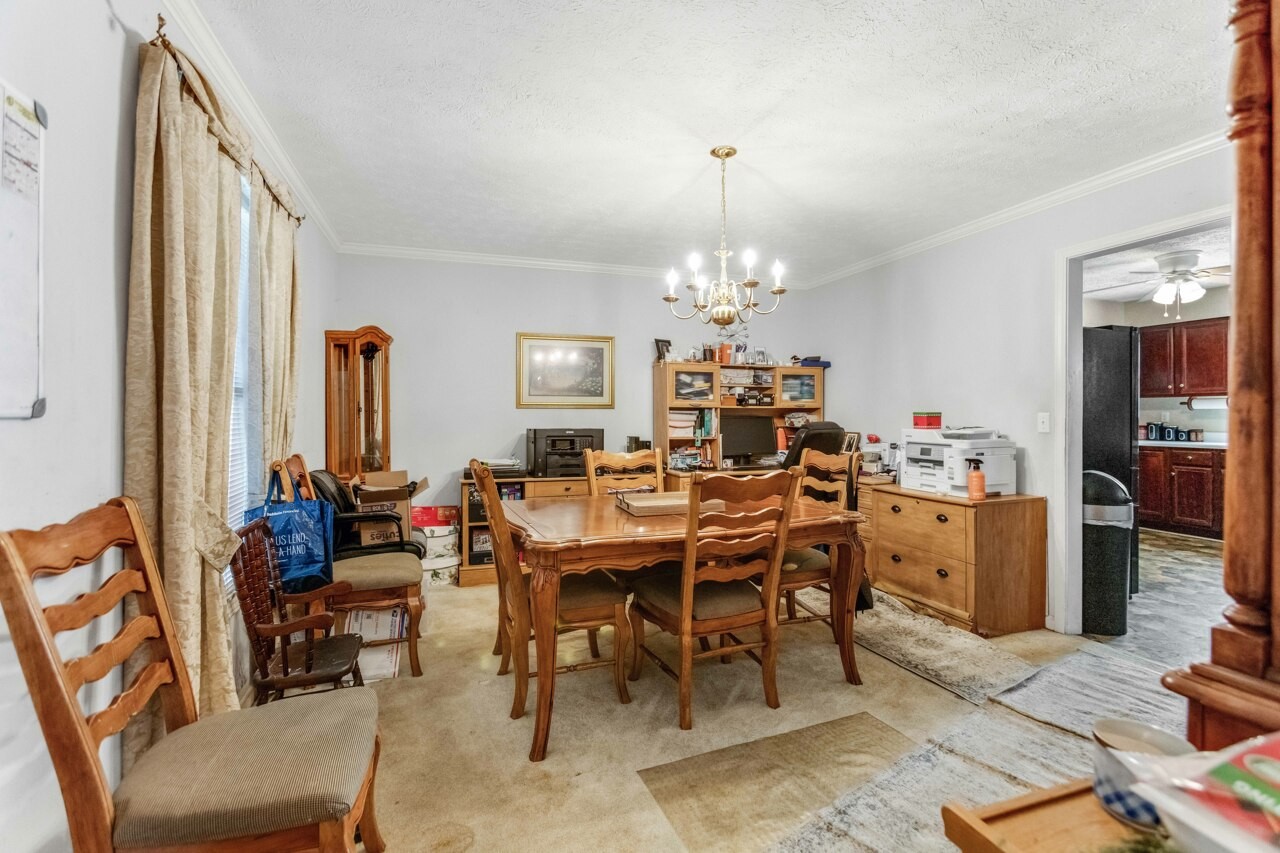 1512 Oak Ridge Court Hopkinsville, KY 42240 - Photo 13 of 24 a view of a dining room with furniture and chandelier