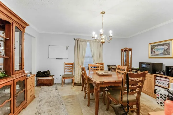 a view of a dining room with furniture and chandelier