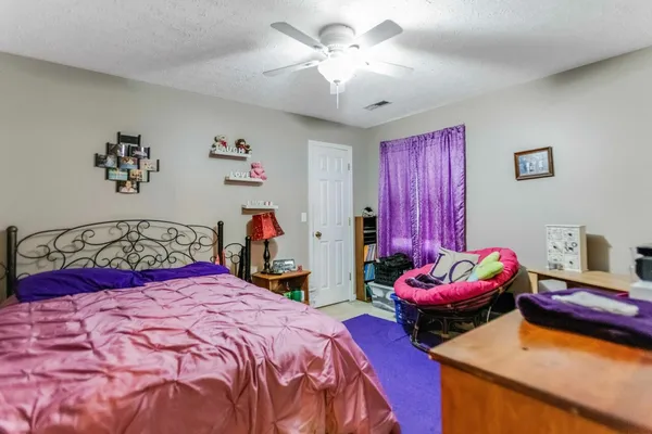 a bedroom with bed and a chandelier