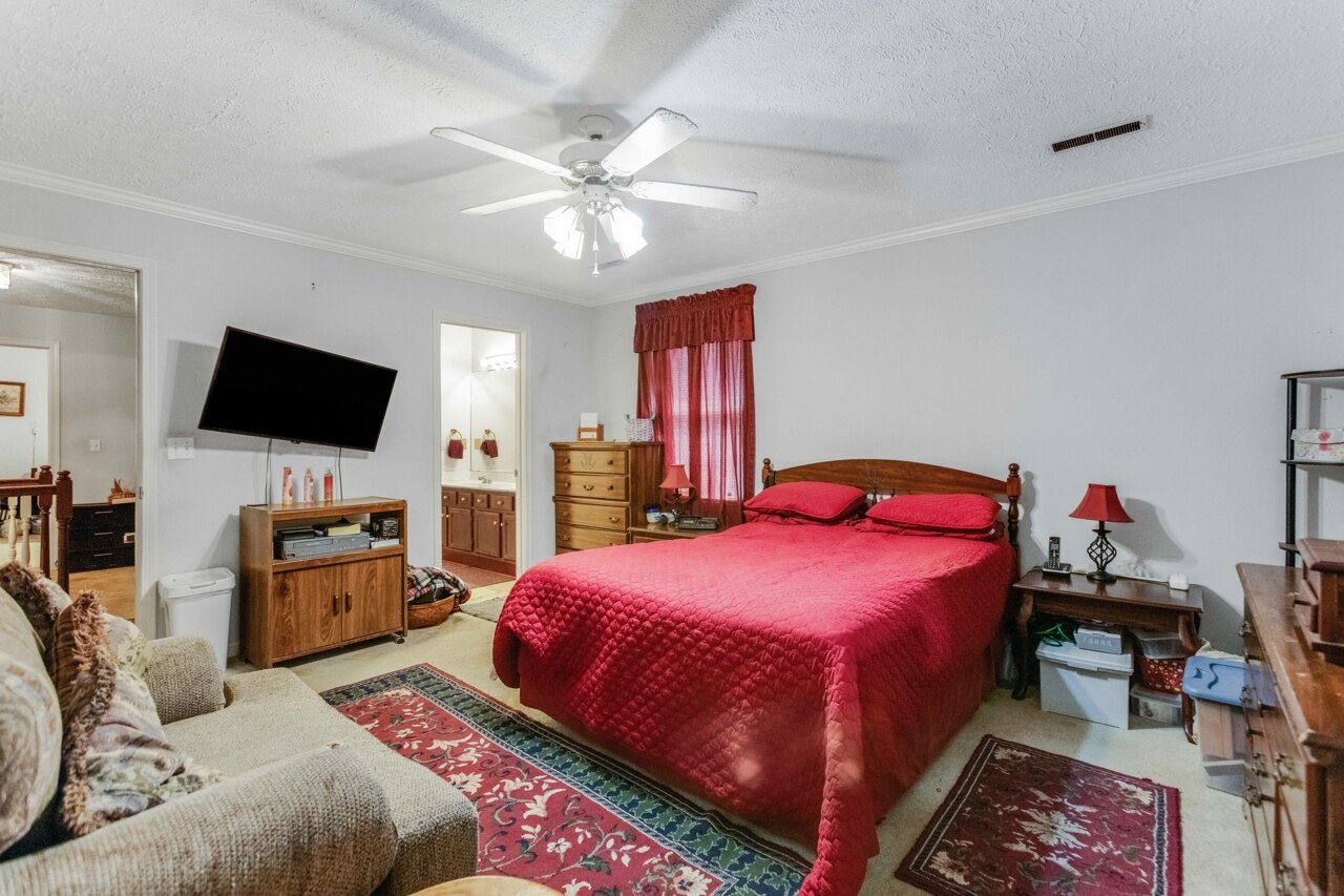 1512 Oak Ridge Court Hopkinsville, KY 42240 - Photo 20 of 24 a bedroom with a bed and a flat screen tv