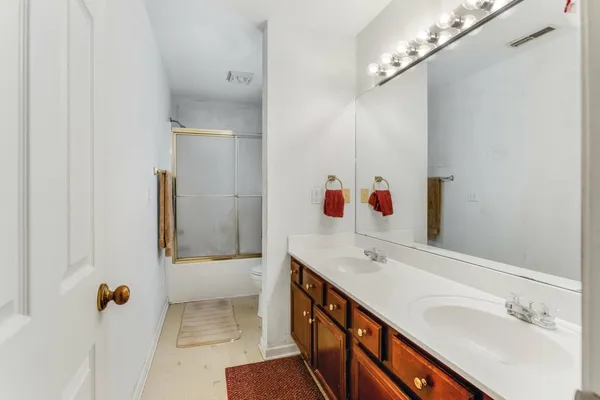 a bathroom with a sink vanity and mirror