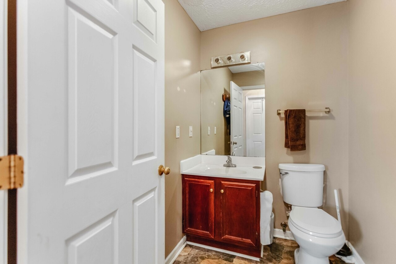 1512 Oak Ridge Court Hopkinsville, KY 42240 - Photo 23 of 24 a bathroom with a toilet a sink and mirror
