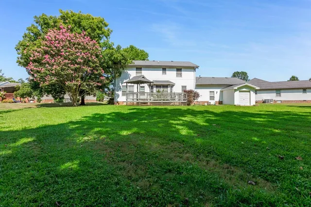 a front view of a house with a garden and yard