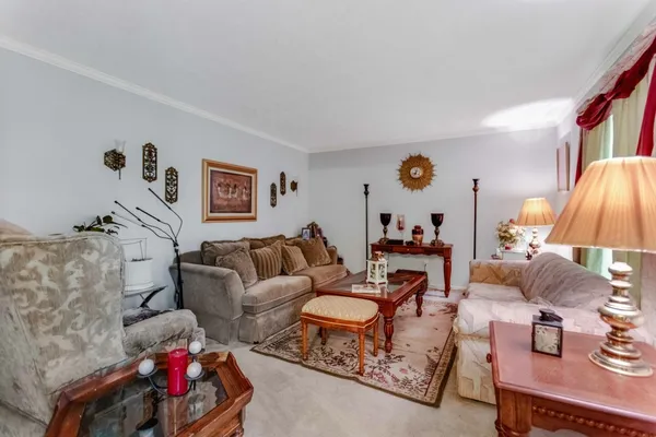 a living room with furniture and a lamp