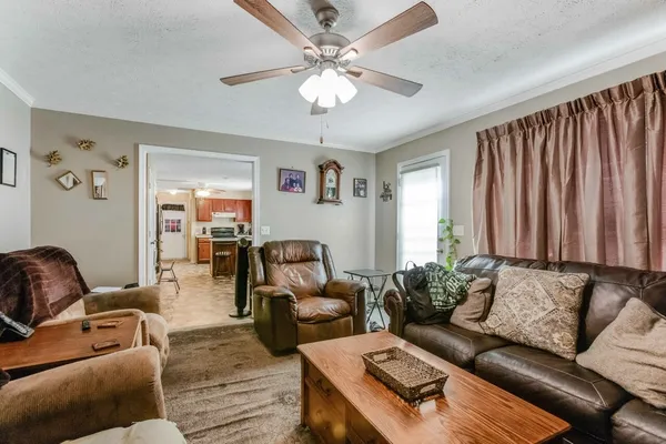 a living room with furniture and a chandelier