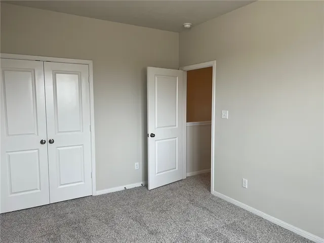 a view of an empty room with closet area