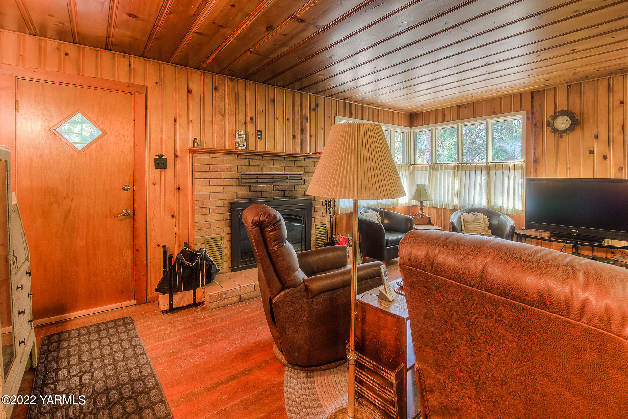 35941 Highway 12, Unit 12 Naches, WA 98937 - Photo 7 of 37 a living room with furniture a flat screen tv and a fireplace