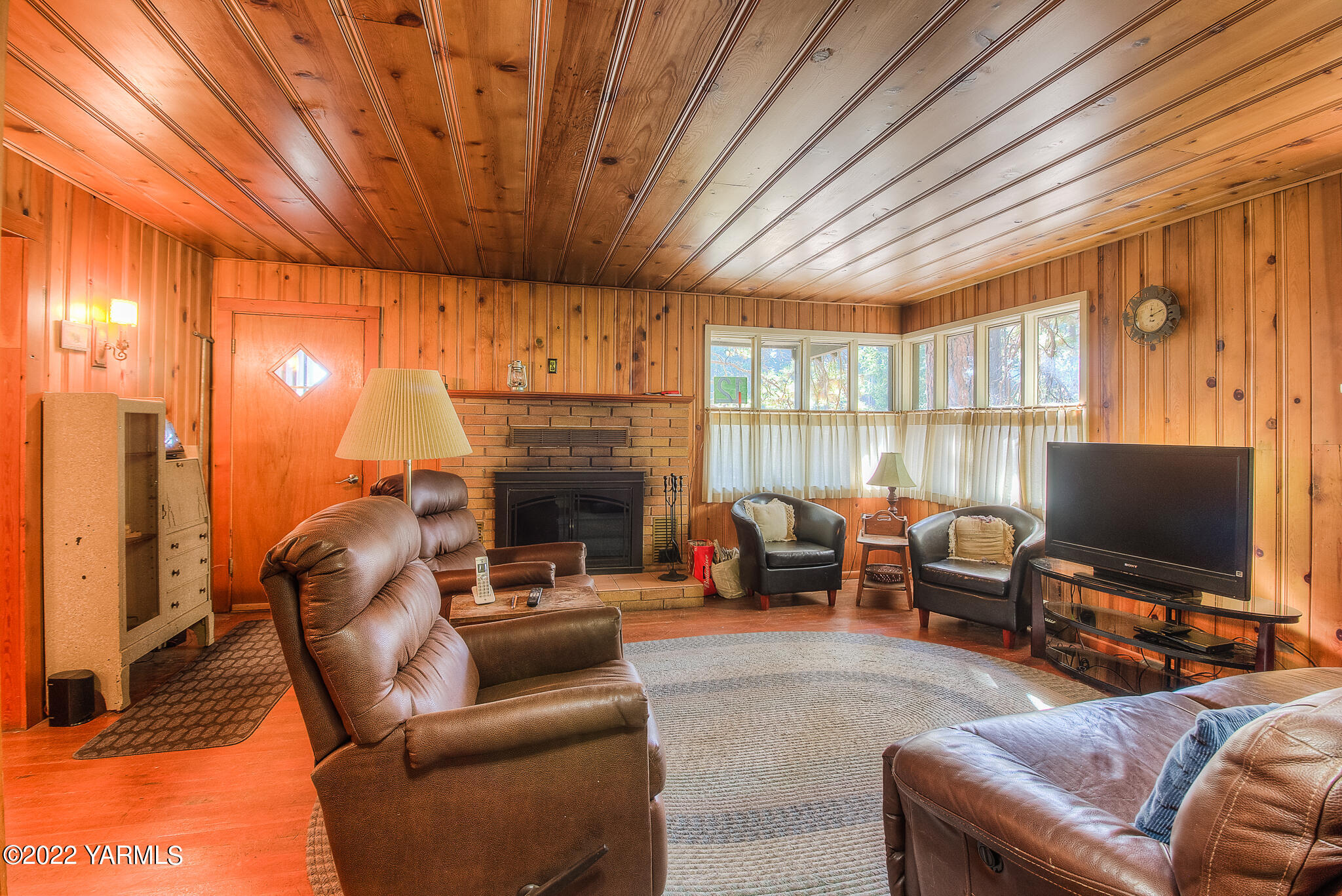 35941 Highway 12, Unit 12 Naches, WA 98937 - Photo 9 of 37 a living room with furniture a fireplace and a flat screen tv