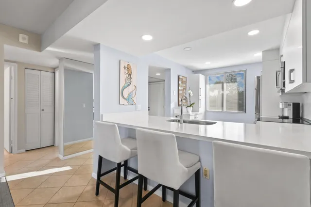 a living room with furniture floor to ceiling window and a flat screen tv